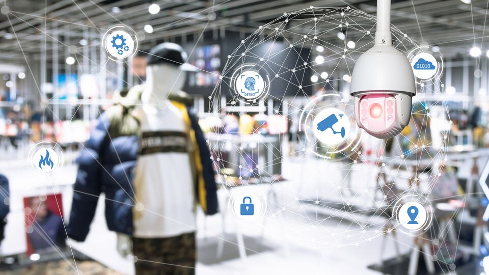 mannequin in retail store with surveillance camera in foreground overlaid with security technology icons